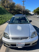 2000 Honda Civic hatchback in silver with sunroof, parked on the street, showcasing its front view