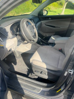 Interior view of a 2016 Hyundai Tucson showing seats and dashboard, in good mechanical condition.