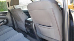 Interior view of a 2016 GMC Yukon with clean gray seats and well-maintained back row