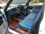Interior view of a well-maintained 1982 GMC S-15 Sierra Classic pickup truck with blue seats.