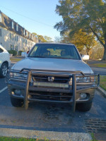 Front view of a 2001 Honda Passport EX RWD parked, showing wear and tear, available for sale at $2500.